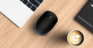 a computer mouse next to a cup of coffee